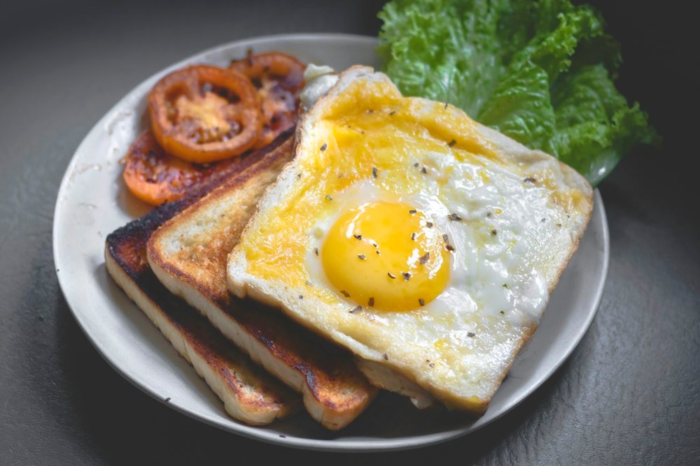 Breakfast plate with eggs, pancakes, and coffee